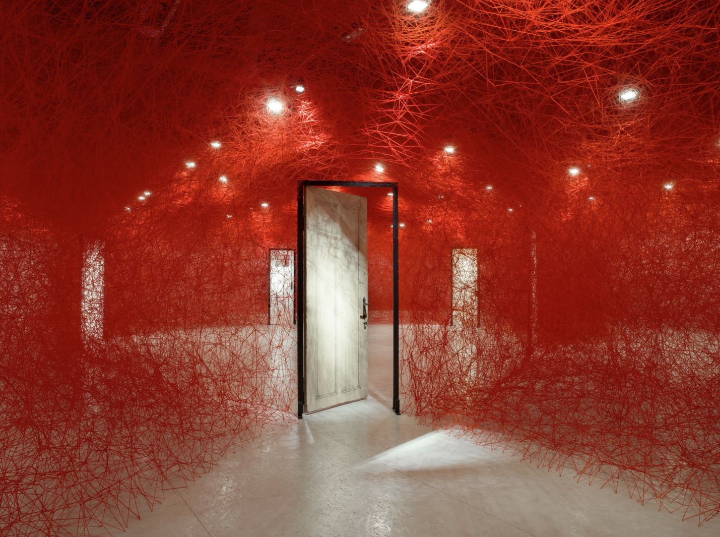 ‘Tracing Boundaries’ by Chiharu Shiota. Installation: wool, metal frame, door. EMMA – Espoo Museum of Modern Art, Espoo, Finland. Courtesy of Saastamoinen Foundation / EMMA – Espoo Museum of Modern Art. 2021. Photo: Paula Virta / EMMA – Espoo Museum of Modern Art. © DACS, London, and the artist, 2024. Permission to use photo granted from DACS, London.