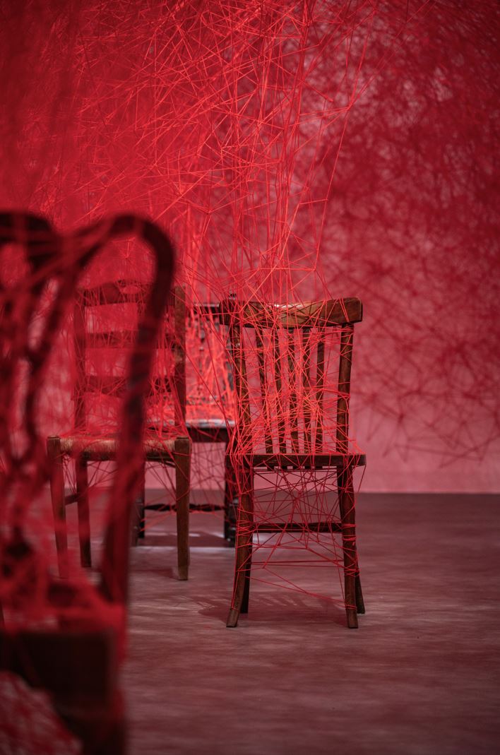 ‘Everyone, a Universe’ by Chiharu Shiota. Installation: chair, wool. Fundació Antoni Tàpies, Barcelona, Spain. 2024. Photo by Pep Herrero. © DACS, London, and the artist, 2024. Permission to use photo granted from DACS, London.